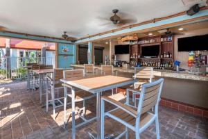 a restaurant with a table and chairs and a bar at Holiday Inn Resort Orlando - Lake Buena Vista by IHG in Orlando