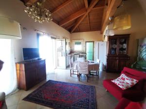 a living room with a red couch and a table at Casamare Hotel in San Vincenzo