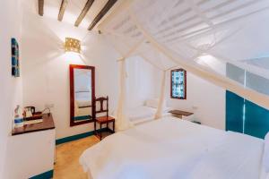 Llit o llits en una habitació de Mchanga Zanzibar