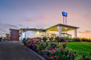a building with a clock on top of it at Motel 6-Grand Rivers, KY in Grand Rivers