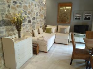 uma sala de estar com um sofá branco e uma parede de pedra em Valley View Lodge em Anópolis