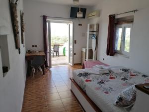 a bedroom with a bed and a table and a window at Countryside Retreat 2 in Agios Arsenios