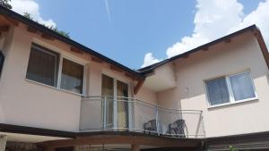 a building with a balcony with chairs on it at Apartman Panorama in Jajce +4 photos