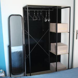 a bathroom with a mirror and a black closet at La Demeure de Cathy in Agneaux
