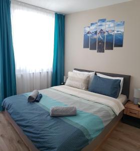 a bedroom with a large bed with blue curtains at KLEPALSKI - Mountain Studio in Borovets