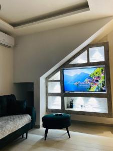 a living room with a flat screen tv in a window at ID apartments in Tivat