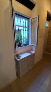 a window in a room with a sink in front of it at Carmona&House in Seville +8 photos