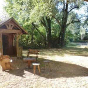 a park with a bench and a picnic shelter at Domaine de La Héllière in Lailly-en-Val