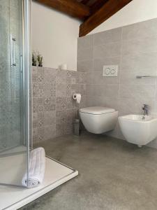 a bathroom with a shower and a tub and a sink at Appartamento I Boschetti in Magliano Alpi