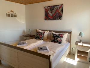 a bedroom with two beds and a painting on the wall at Apartment Weinberg in Ürzig