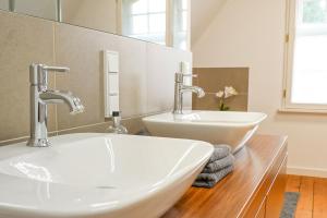 a bathroom with two sinks and two faucets at Traumhaft wohnen in Jugendstilvilla in Speyer +35 photos