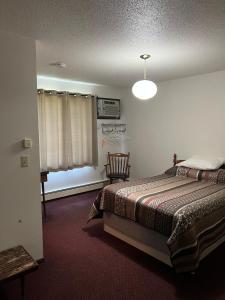 a bedroom with a bed and a window at Barnesville Motel 