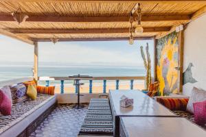 a living room with a view of the ocean at L'Auberge Taghazout in Taghazout