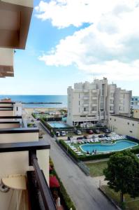 a view of a city with buildings and a swimming pool at Hotel Apollo in Rimini