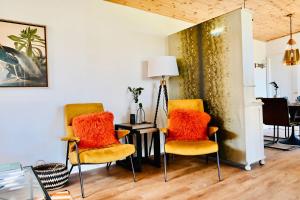 The Stables Hideaway في ليانيلي: غرفة معيشة مع كرسيين وطاولة