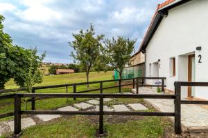 a wooden fence next to a white building at BENEDICTA FAMILY ROOMS in Suances