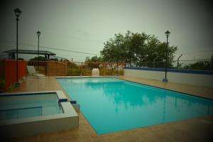 a large blue swimming pool in a yard at Rivera Maya in Rivera
