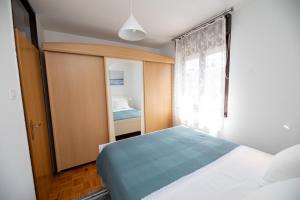 a bedroom with a bed and a window at Iva in Zagreb