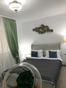 a bedroom with a bed with a window and a mirror at RELAX Downtown Suite in Constanţa