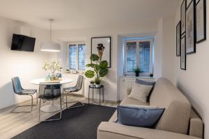 a living room with a couch and a table at New Central Studios in Ljubljana +45 photos