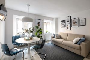 a living room with a couch and a table at New Central Studios with parking in Ljubljana