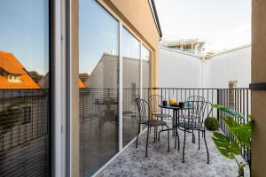 a balcony with a table and chairs on it at New Central Studios with parking in Ljubljana