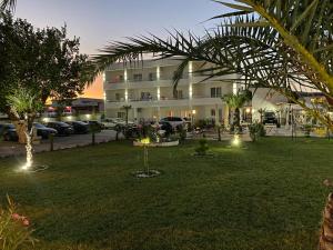 a large building with lights in a yard at Apartments Vila Sara M in Ulcinj