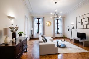 a living room with a couch and a tv at Old Riga Modern and Spacious 2 bedroom Apartment in Rīga