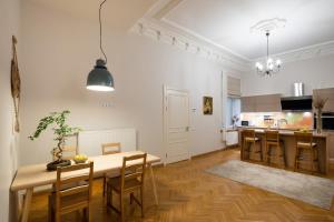 a kitchen and dining room with a table and chairs at Old Riga Modern and Spacious 2 bedroom Apartment in Rīga