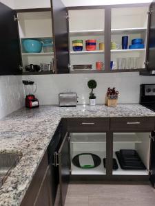 a kitchen with a counter top with a sink at Cozy 1bd in the heart of downtown Dallas!(w/parking) in Dallas