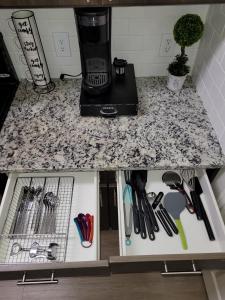 a kitchen counter with a counter top with utensils at Cozy 1bd in the heart of downtown Dallas!(w/parking) in Dallas