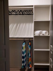 a walk in closet with white curtains and towels at Cozy 1bd in the heart of downtown Dallas!(w/parking) in Dallas