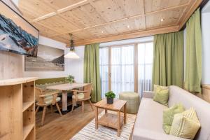 a living room with a couch and a table at Landhaus Dorfbäck in Stumm