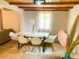 a dining room with a table and chairs at Oliviera - House in Nature in Tympáki