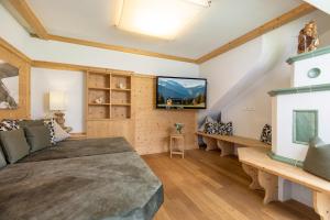 a living room with a couch and a tv at Landhaus Dorfbäck in Stumm