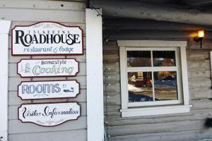 a group of signs on the side of a building at Talkeetna Roadhouse in Talkeetna
