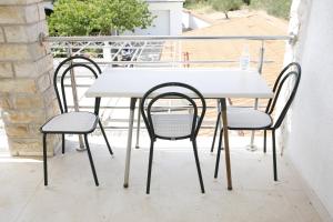 a white table and two chairs on a balcony at Apartments Lepur in Vodice