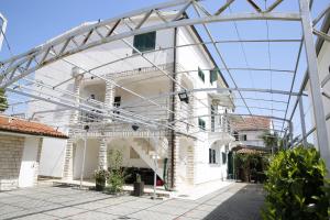 a large white building with a glass roof at Apartments Lepur in Vodice