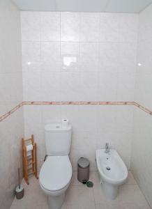 a white bathroom with a toilet and a sink at Charming Private Rooms in an Apartment A2 Penha - Faro in Faro
