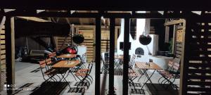 a patio with tables and chairs on a porch at Siesta Pension in Miercurea-Ciuc