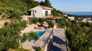 an aerial view of a house with a swimming pool at Olive Stone House in Makarska