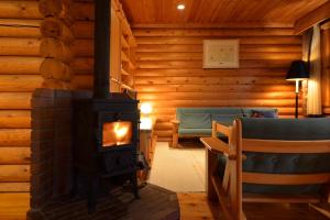 a living room with a fireplace and a couch at Hotel Nidom in Tomakomai
