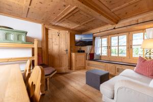 a bedroom with a bunk bed and a living room at Chalet Dorfbäck in Stumm