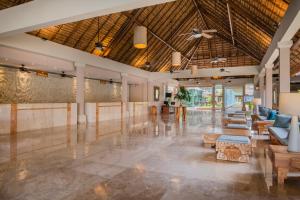 a lobby of a resort with couches and tables at Iberostar Waves Tucán in Playa del Carmen