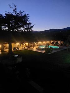 a backyard with two swimming pools at night at Il Paradiso Segreto in Pistoia