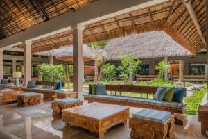 a resort lobby with couches and tables at Iberostar Waves Tucán in Playa del Carmen