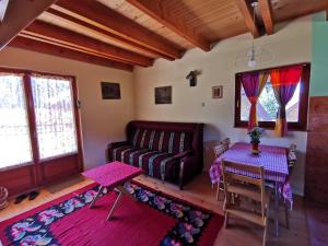 a living room with a couch and a table at Vikendica Dana in Mitrovac