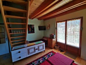 a living room with a bunk bed and a desk at Vikendica Dana in Mitrovac