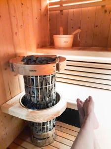 a person is sitting in a sauna at LE COTTAGE DU PARC in Chambéon