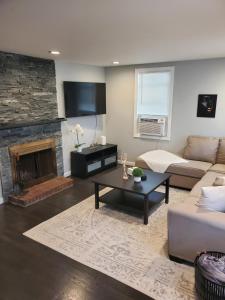 a living room with a couch and a fireplace at Boston's Best Vacation House in Boston